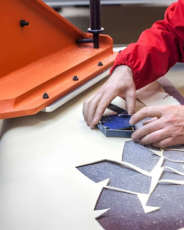 Worker cutting Leather Gloves on Press in Vixen Leather Factory