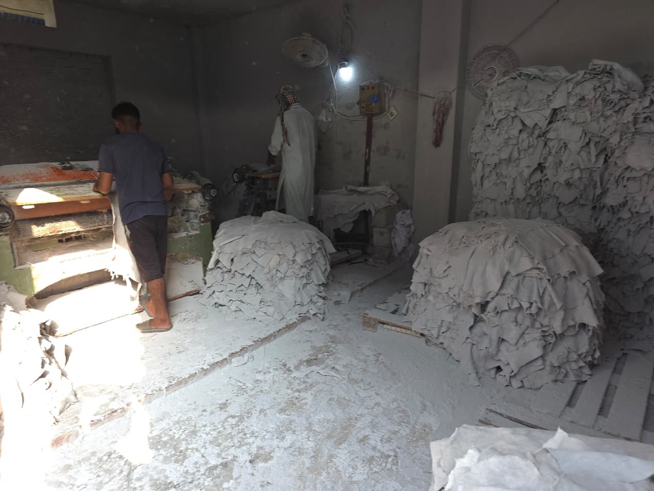 Leather buffing process with workers preparing hides at Vixen Leather tannery